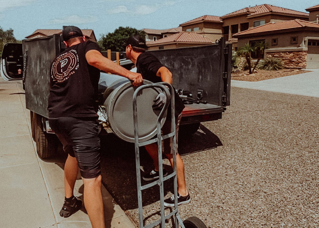 A collection of bulk trash items piled on a Phoenix neighborhood curb.